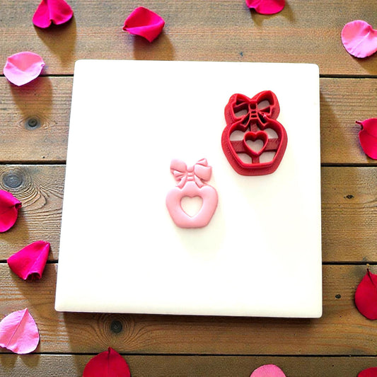Heart perfume bottle cutter and clay piece shown together