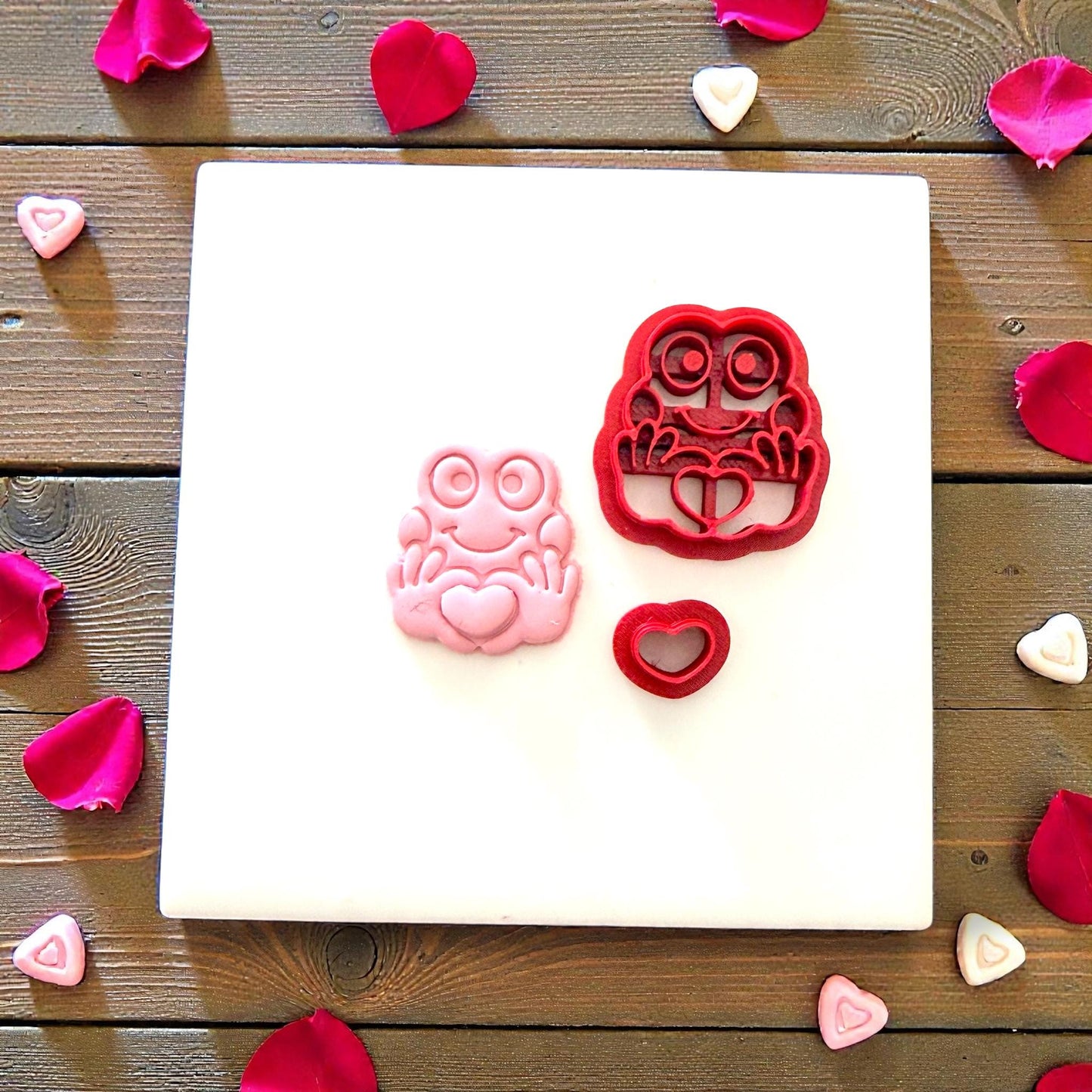 Frog cutter set with clay frog and heart on white tile