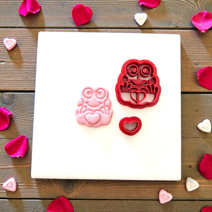 Frog cutter set with clay frog and heart on white tile