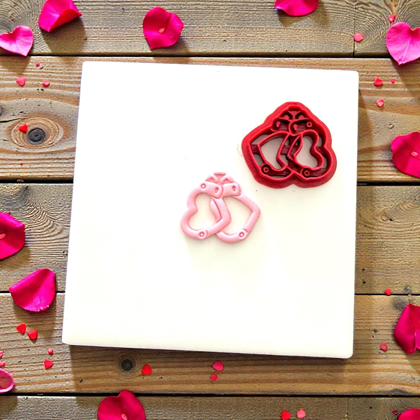 Heart handcuff cutter beside finished clay piece