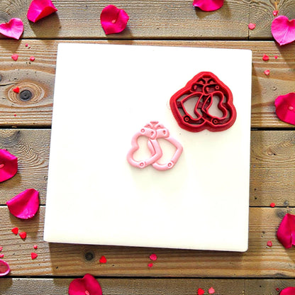 Heart handcuff cutter beside finished clay piece