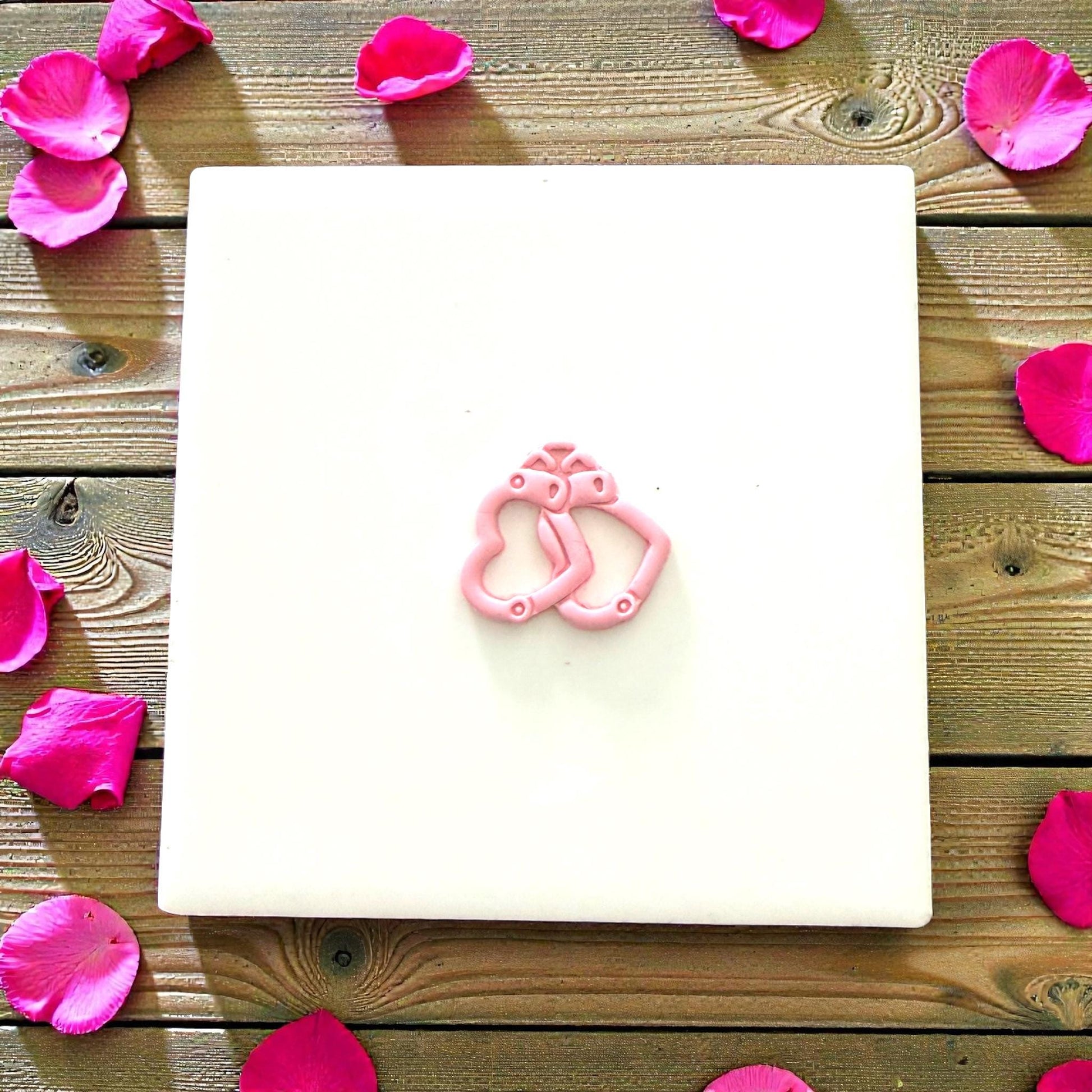 Heart handcuff clay charm on display tile