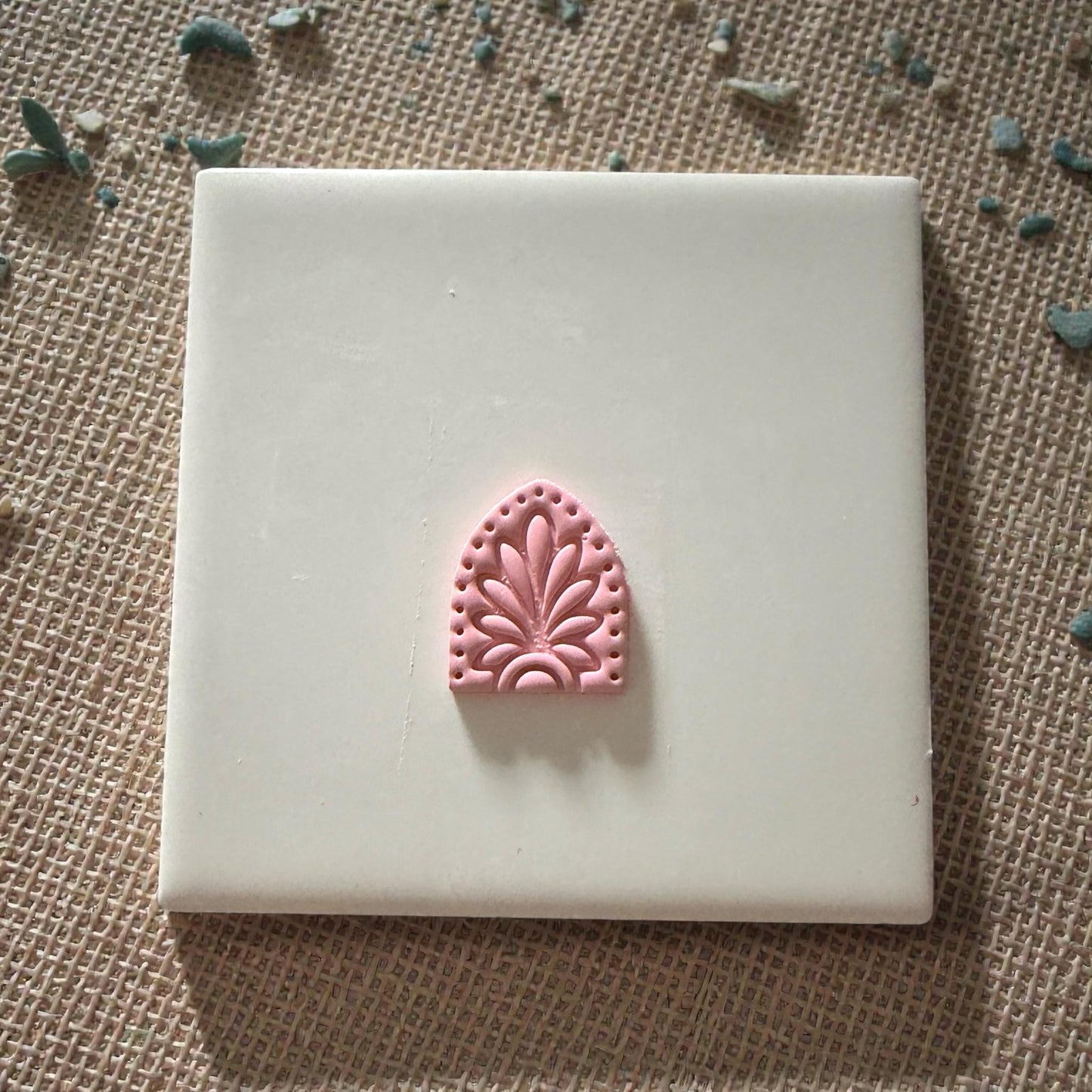 small floral arch clay imprint displayed on tile
