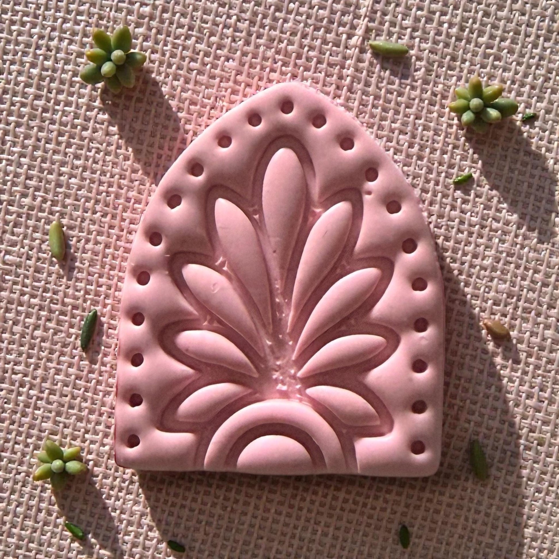 close-up pink clay floral arch impression