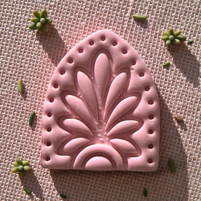close-up pink clay floral arch impression