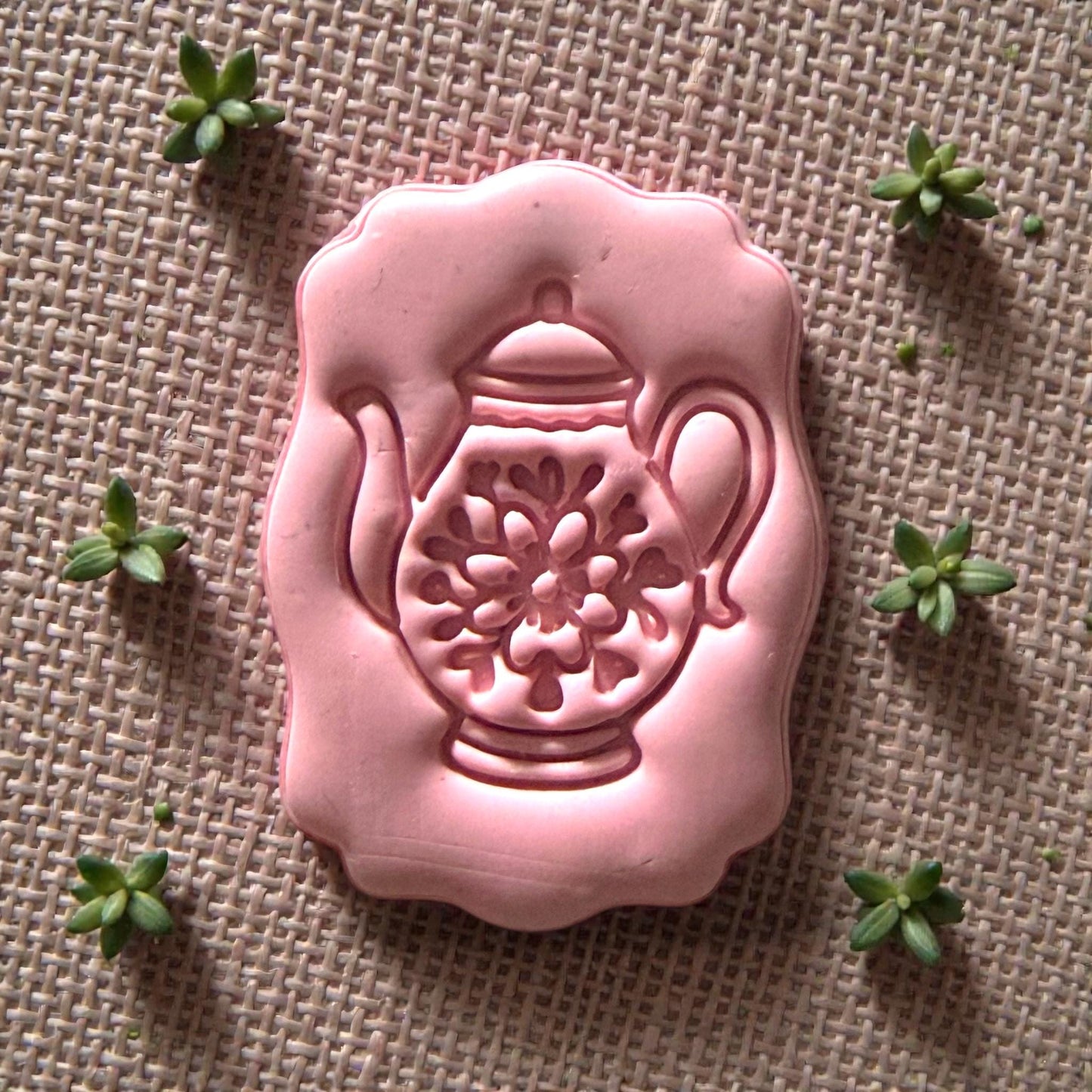small teapot polymer clay cutter displayed on white tile