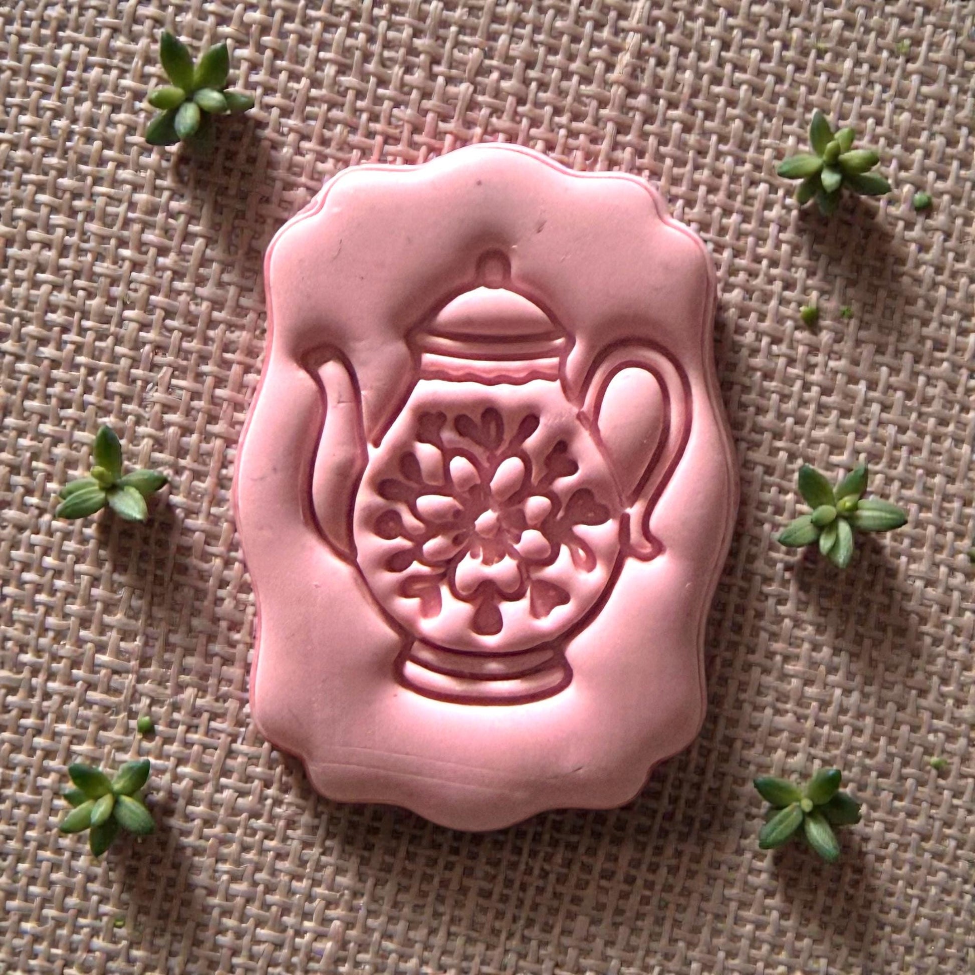 small teapot polymer clay cutter displayed on white tile