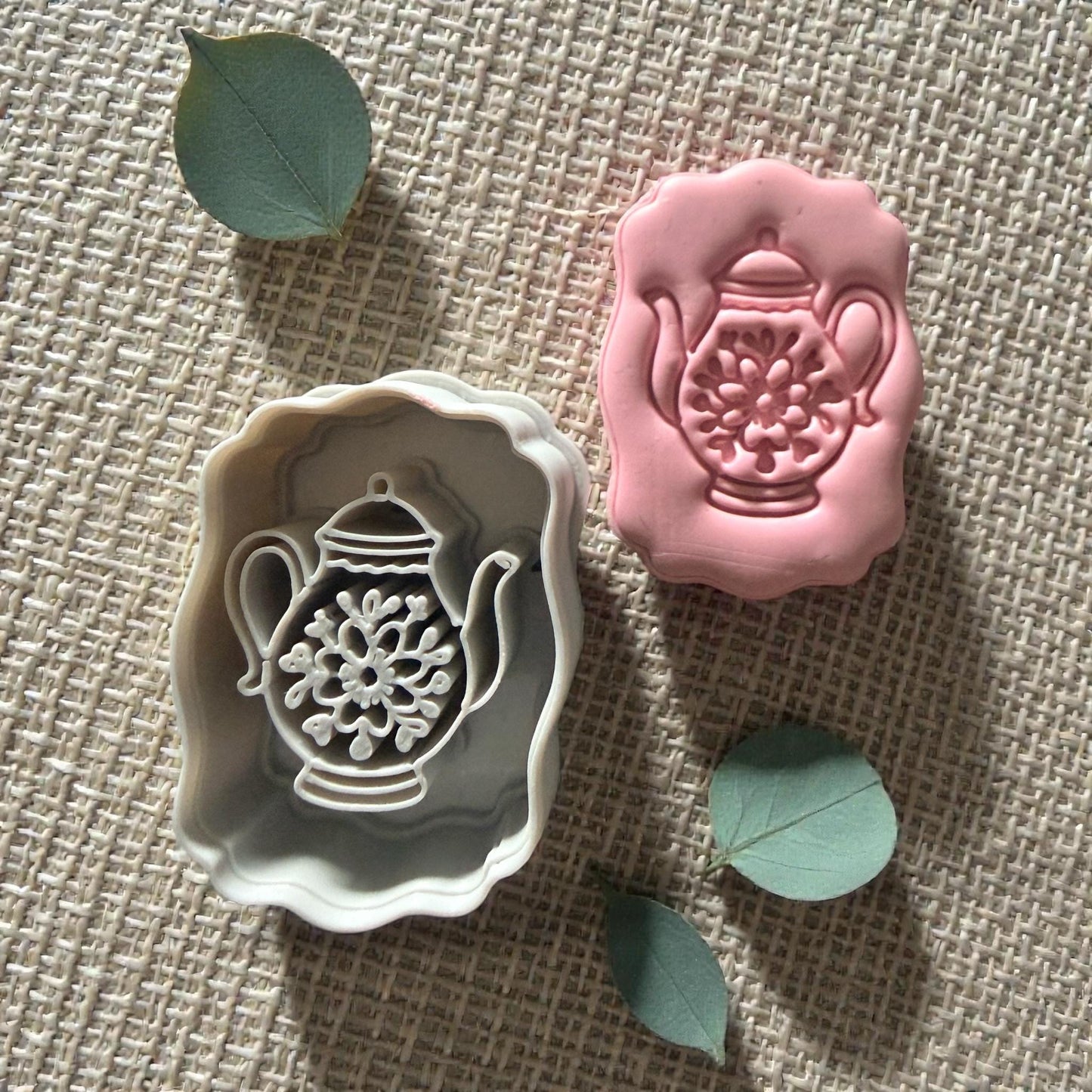 pink teapot clay impression on square clay slab