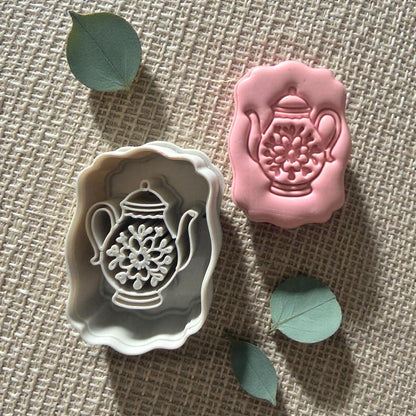 pink teapot clay impression on square clay slab