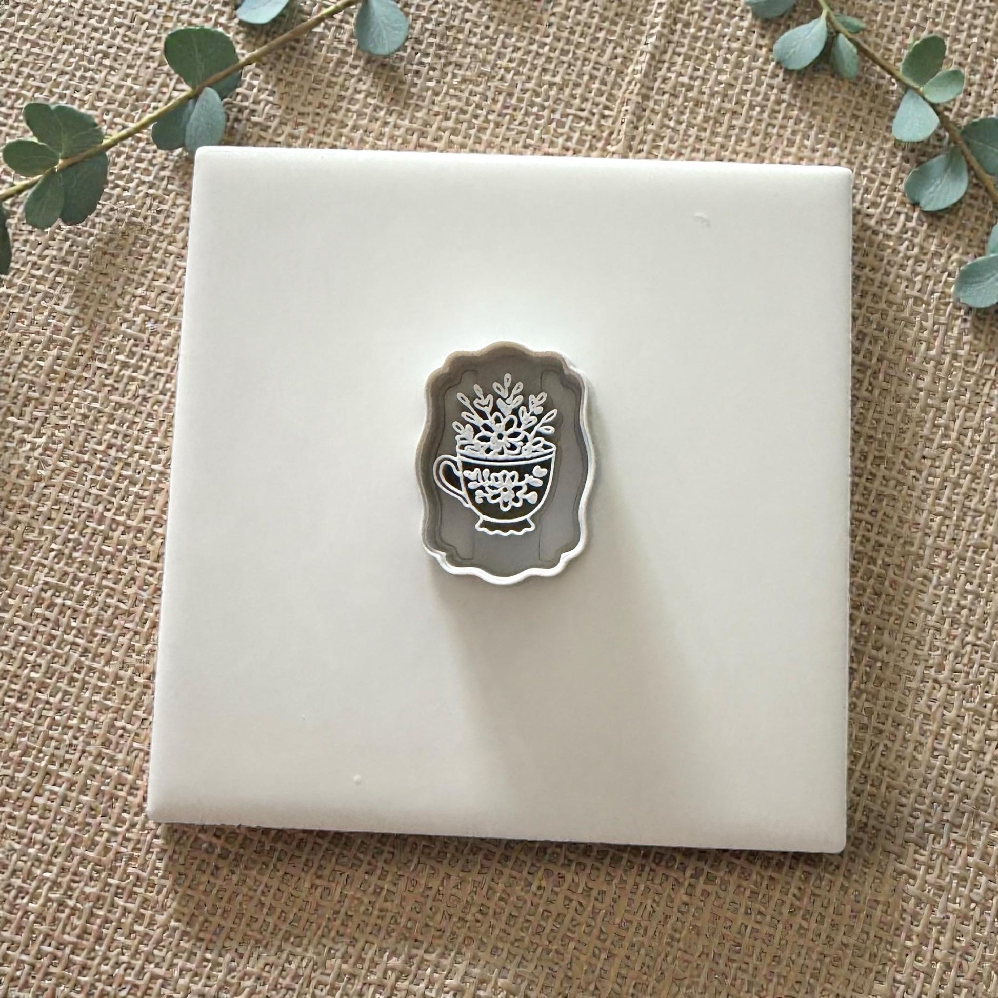 small teacup clay cutter displayed on white tile