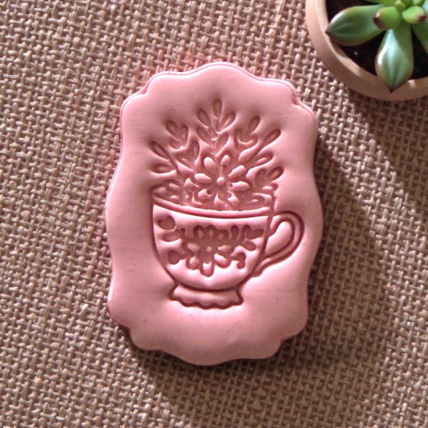 pink clay impression of floral teacup design