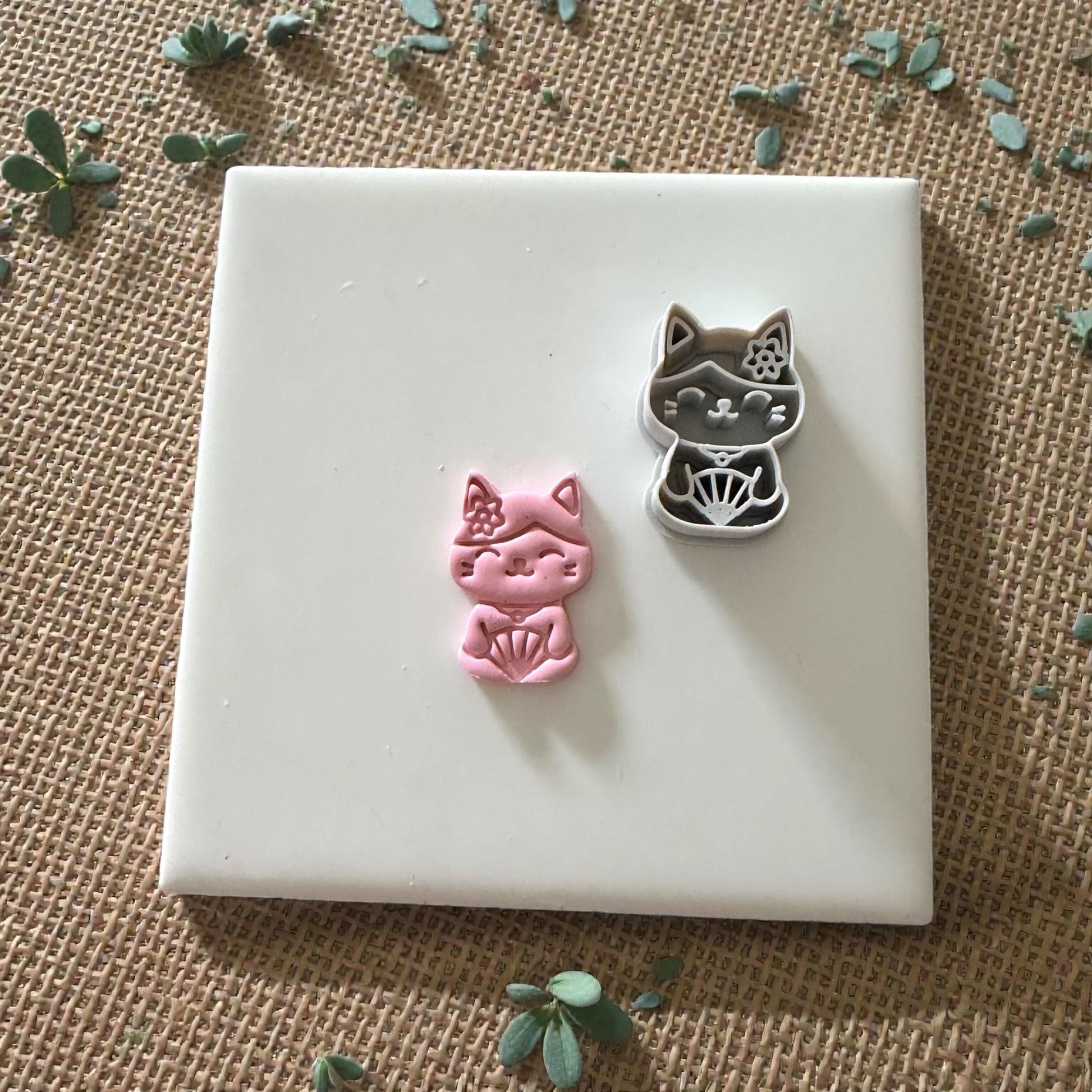 kawaii cat cutter with pink clay impression beside it