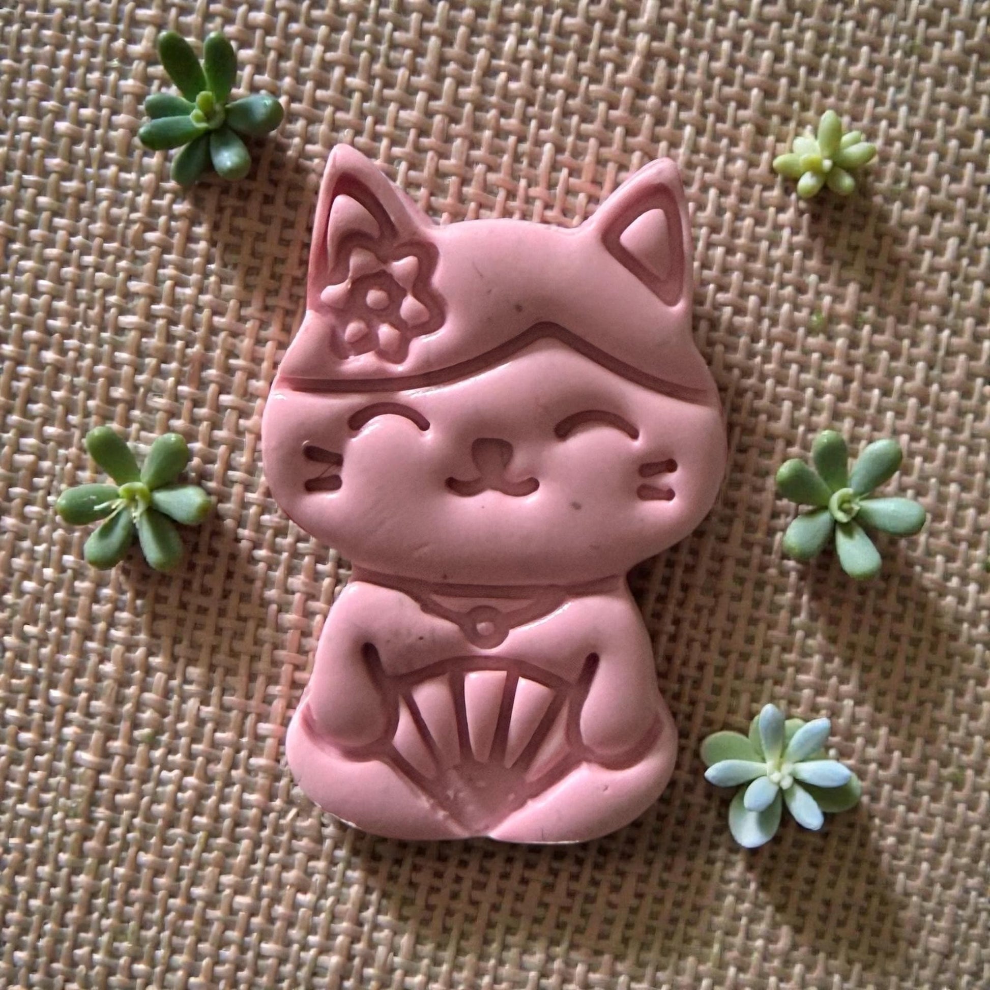 large pink clay impression of kawaii cat with fan