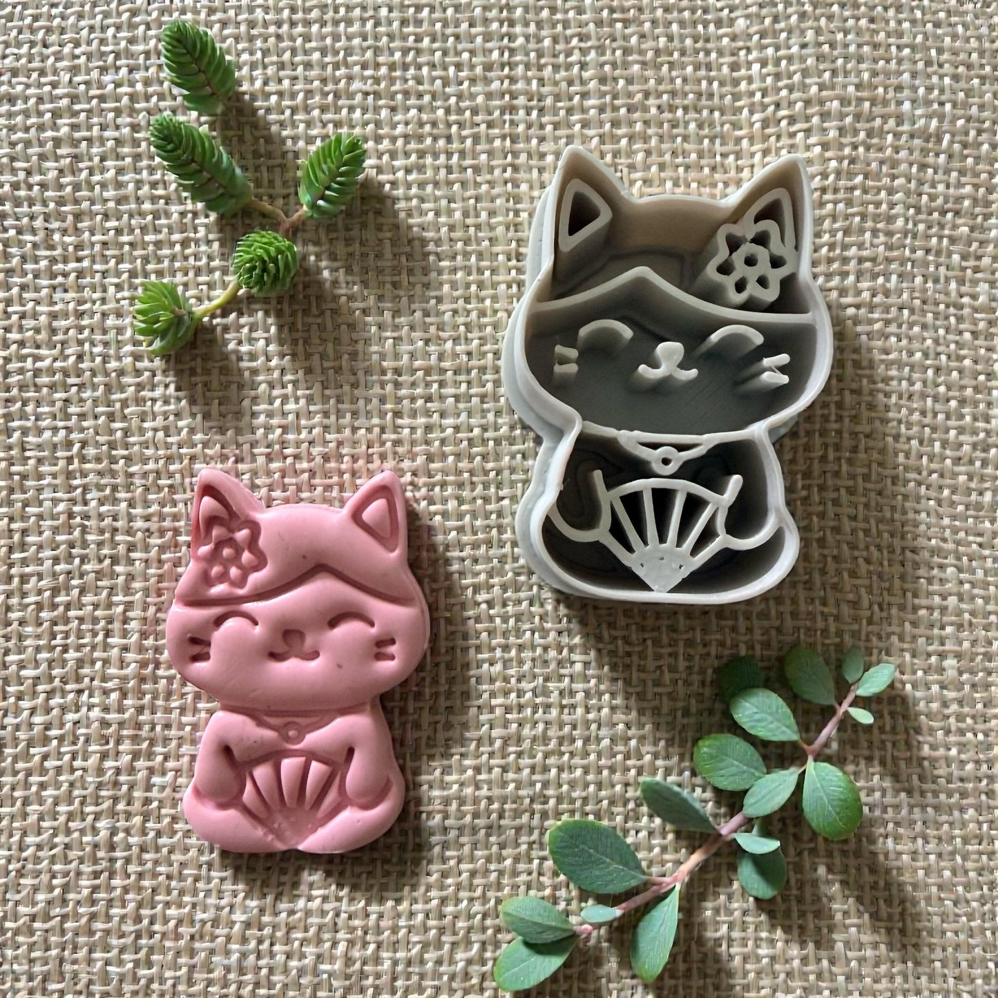 kawaii cat cutter with pink clay impression beside it
