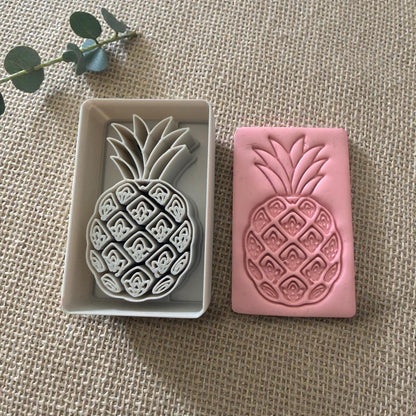 pineapple clay cutter next to clay impression
