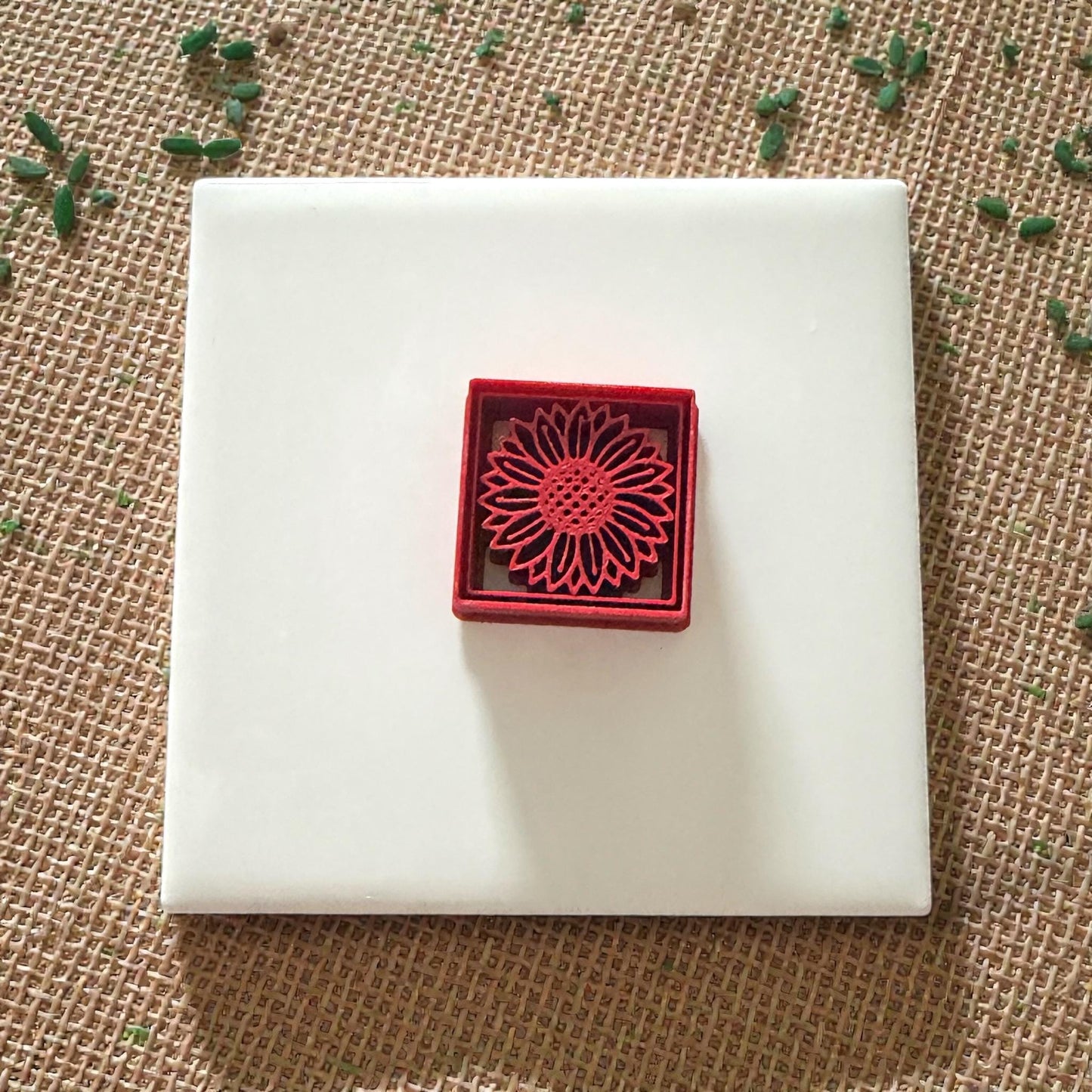 sunflower clay cutter displayed on white tile for size reference