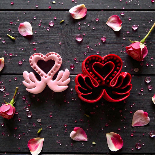 red and pink love swan cutters with scattered petals