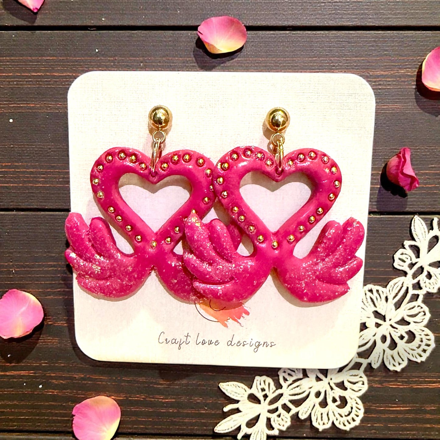 pink love swan earrings on display card