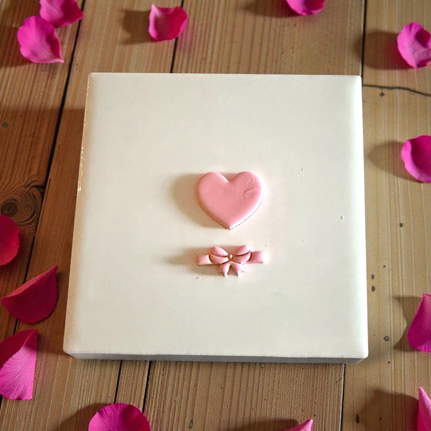 heart and bow clay shapes displayed on white tile