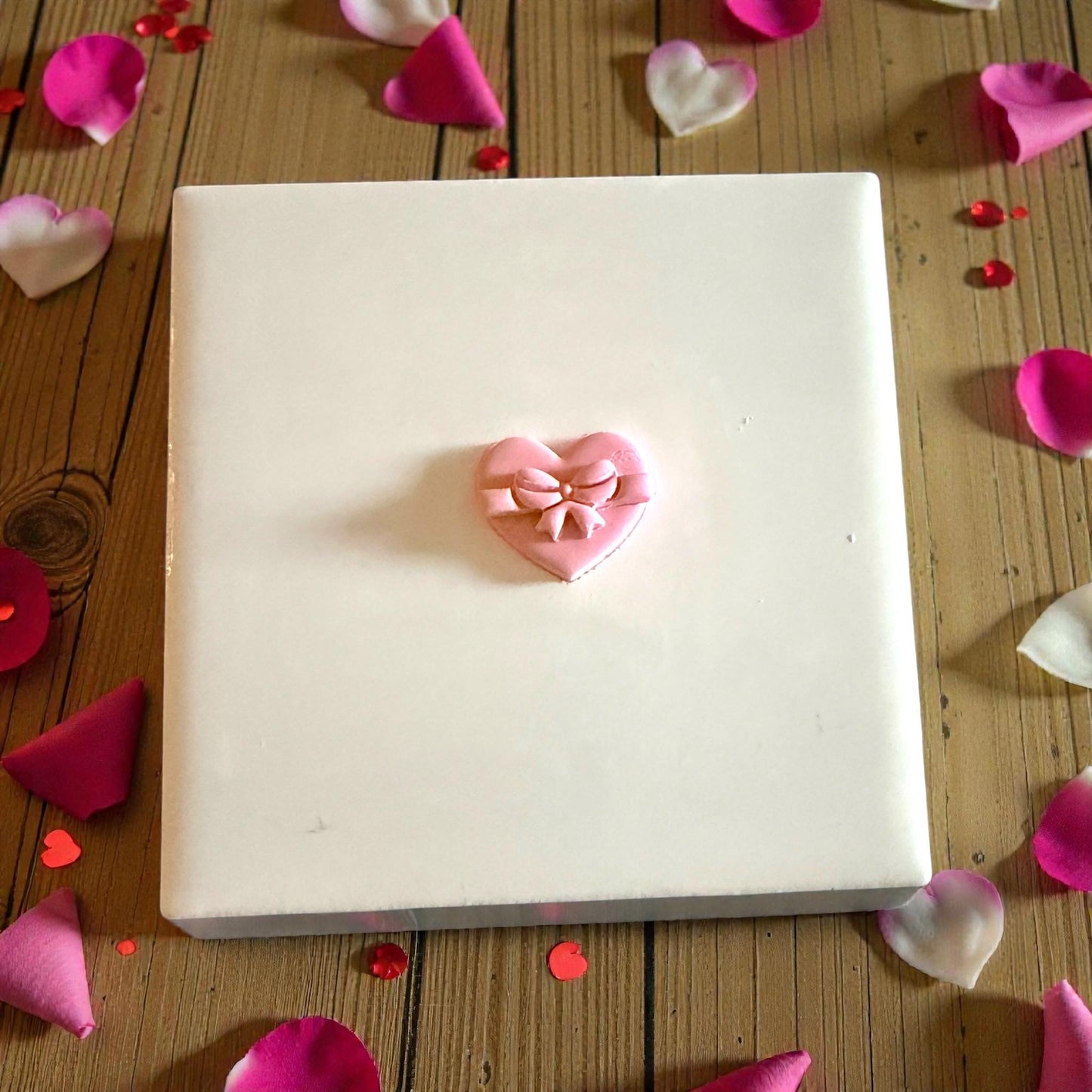 small heart bow clay piece on center tile