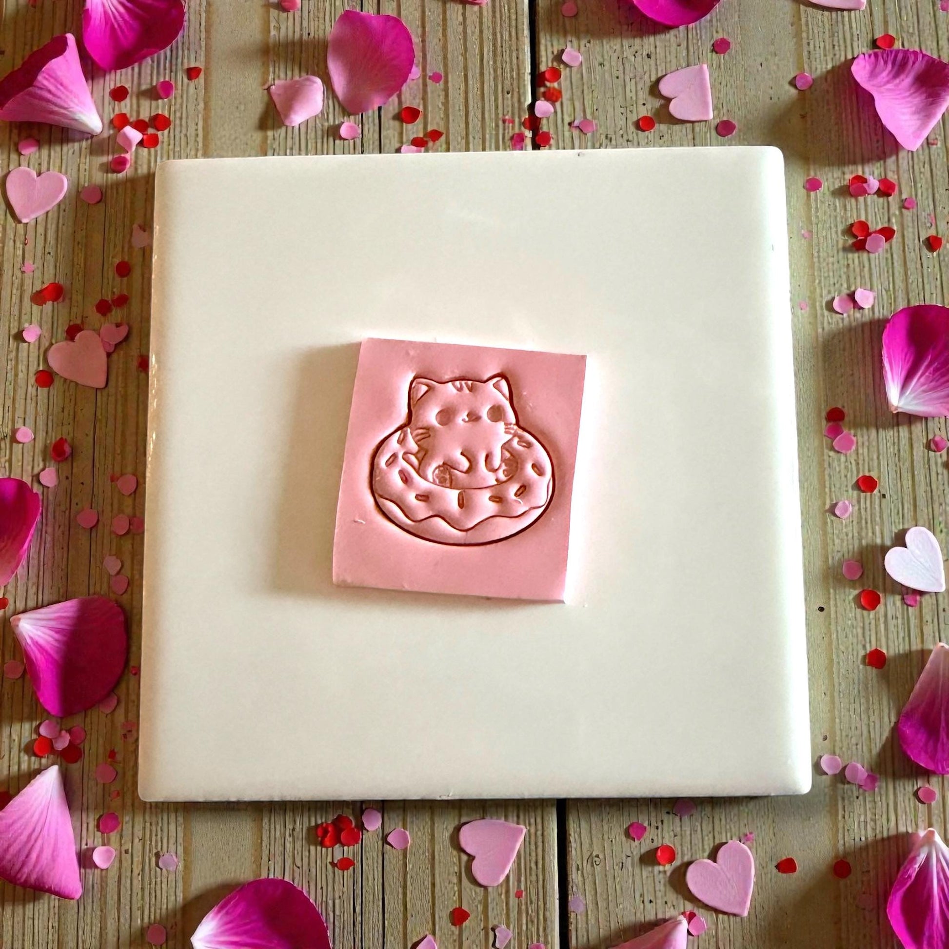 kitty doughnut clay impression on tile with pink petals