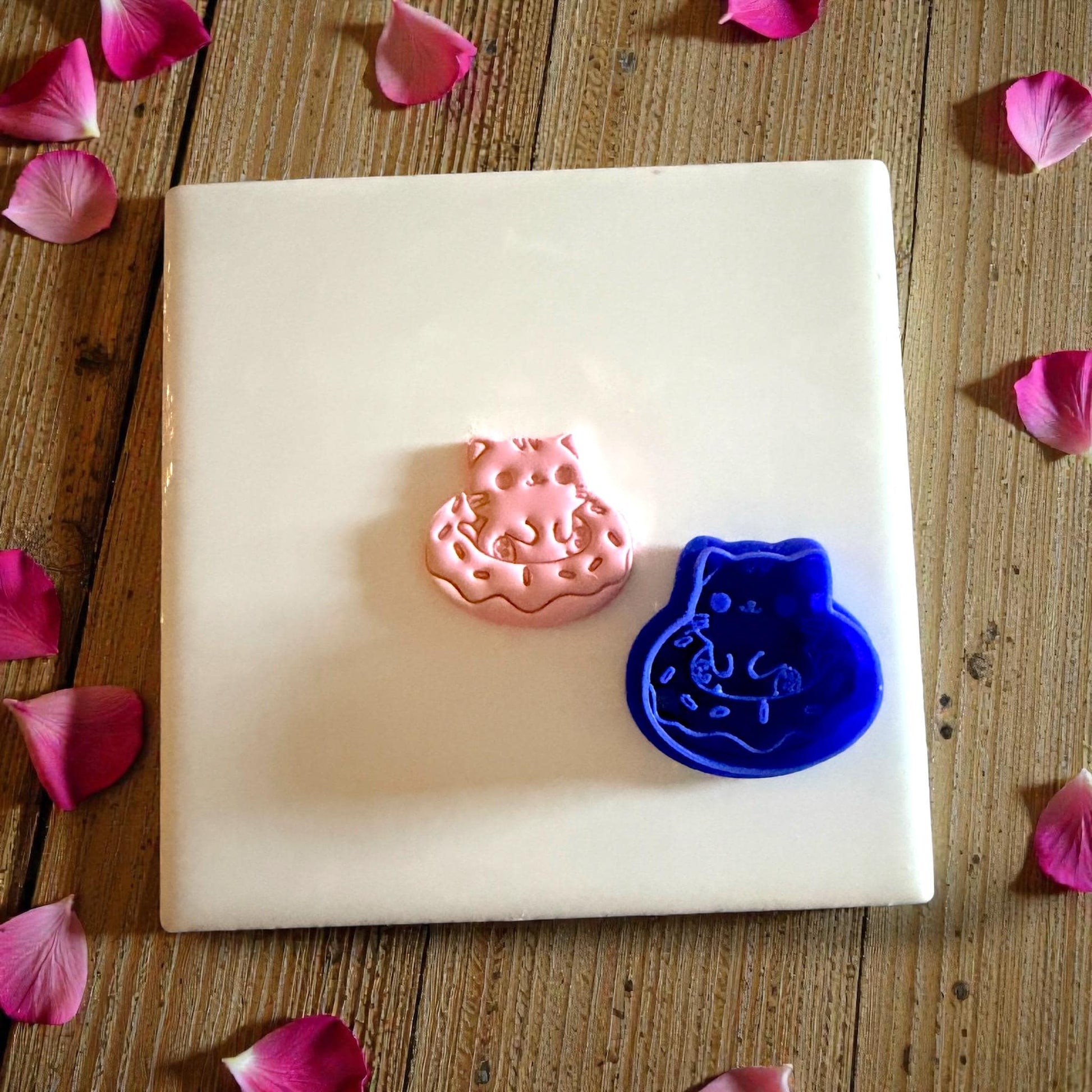 kitty donut clay piece beside blue cutter