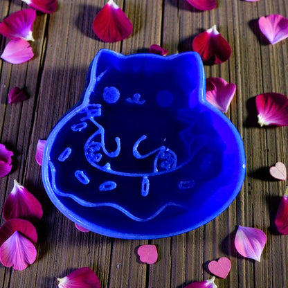 closeup deep blue kitty doughnut cutter with petals