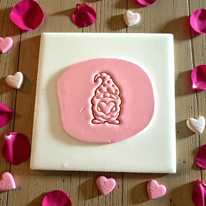 pink clay impression of Valentine gnome with heart