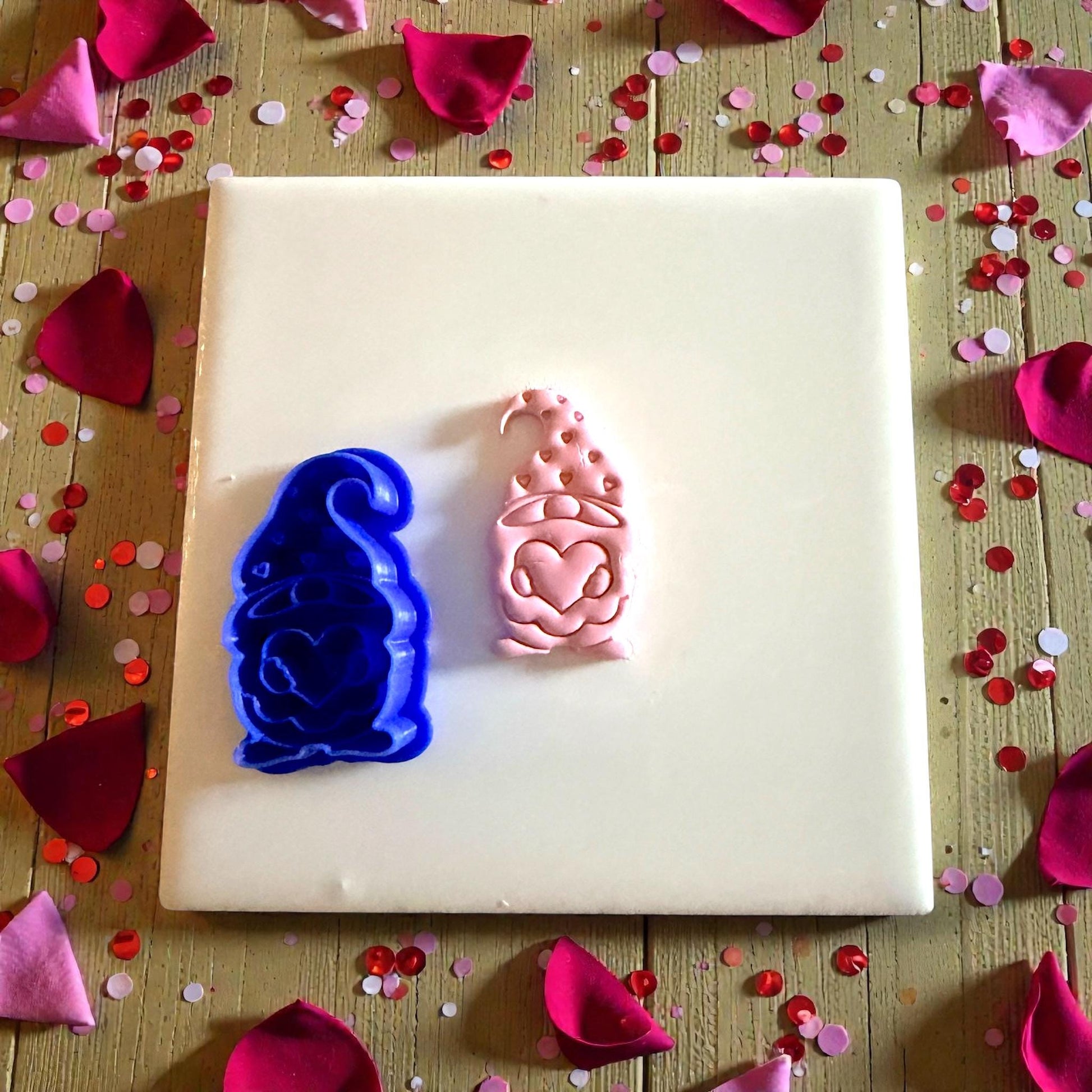 blue cutter and pink gnome clay impression side by side