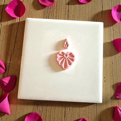 heart floral clay design centered on white tile