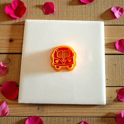 orange love bus cutter centered on white tile