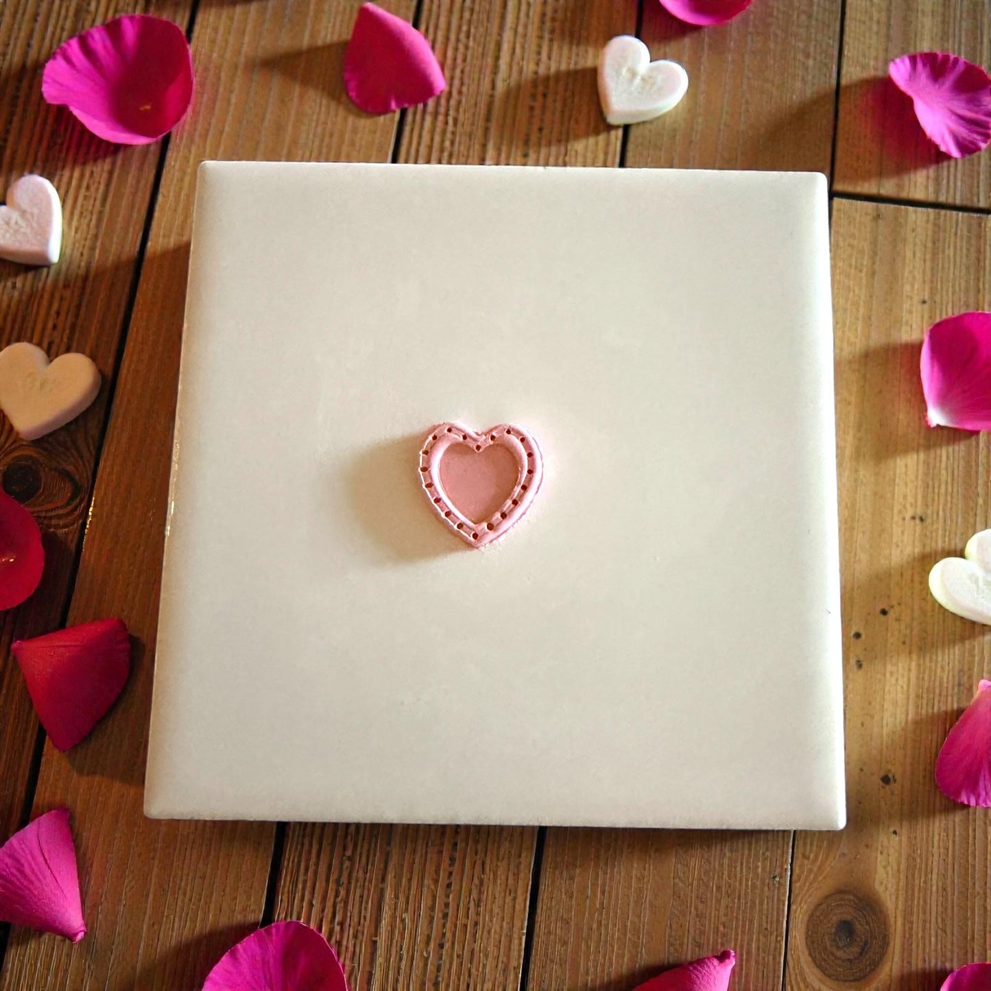 small pink dotted heart shape centered on tile