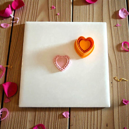 pink heart clay piece and orange cutter displayed together