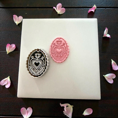 folk heart cutter and clay impression displayed together