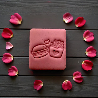 Pink clay slab with burger and fries Valentine impression and floral petals