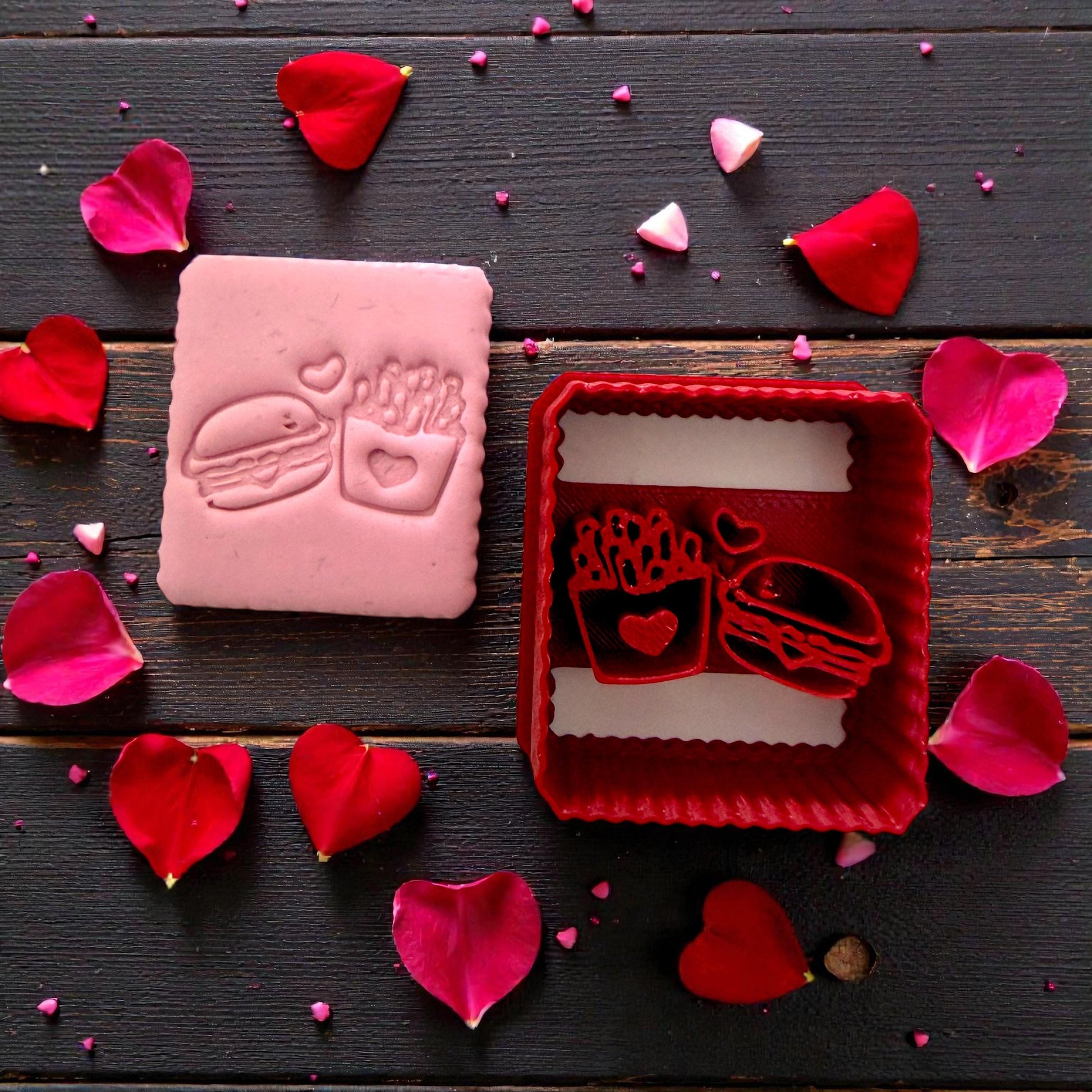 Pink clay slab with burger and fries Valentine impression and floral petals and red cutter