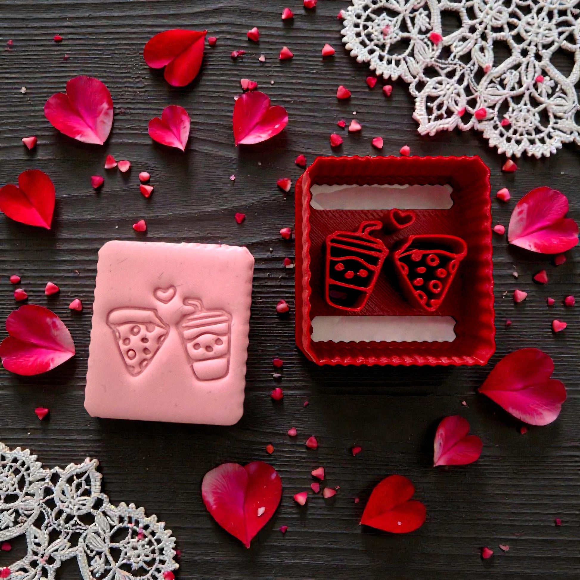 Pink up close pink slab of pizza and drink with red matching cutter