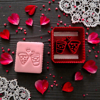 Pink up close pink slab of pizza and drink with red matching cutter