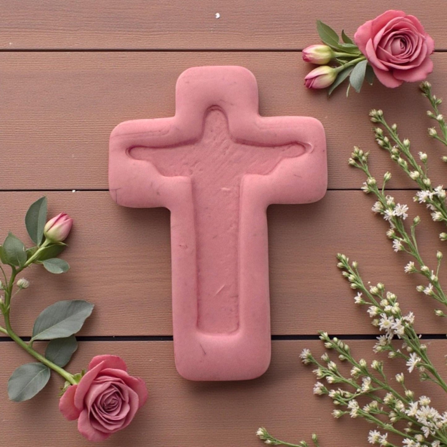 large pink clay cross close up