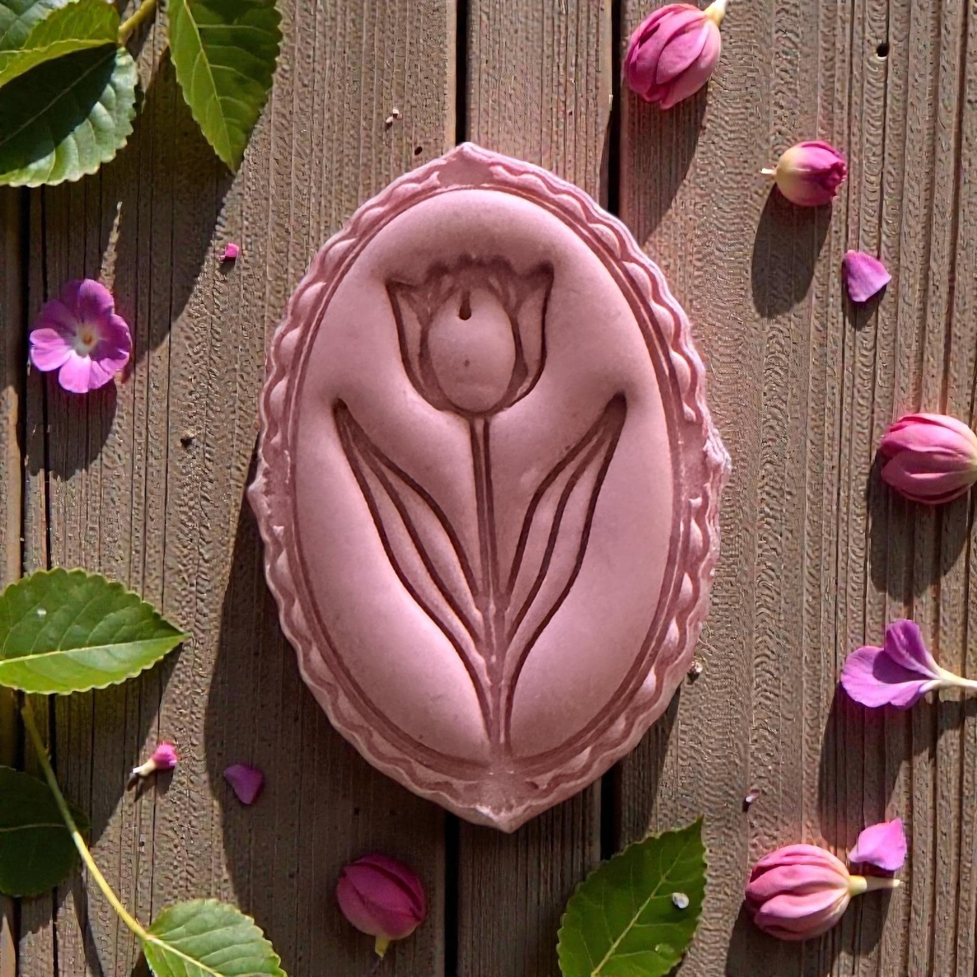 Close-up pink tulip clay impression with floral border