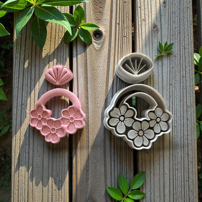 clay cutters with flowers on wood background