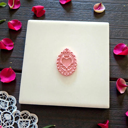 decorative heart-frame clay imprint centered on tile