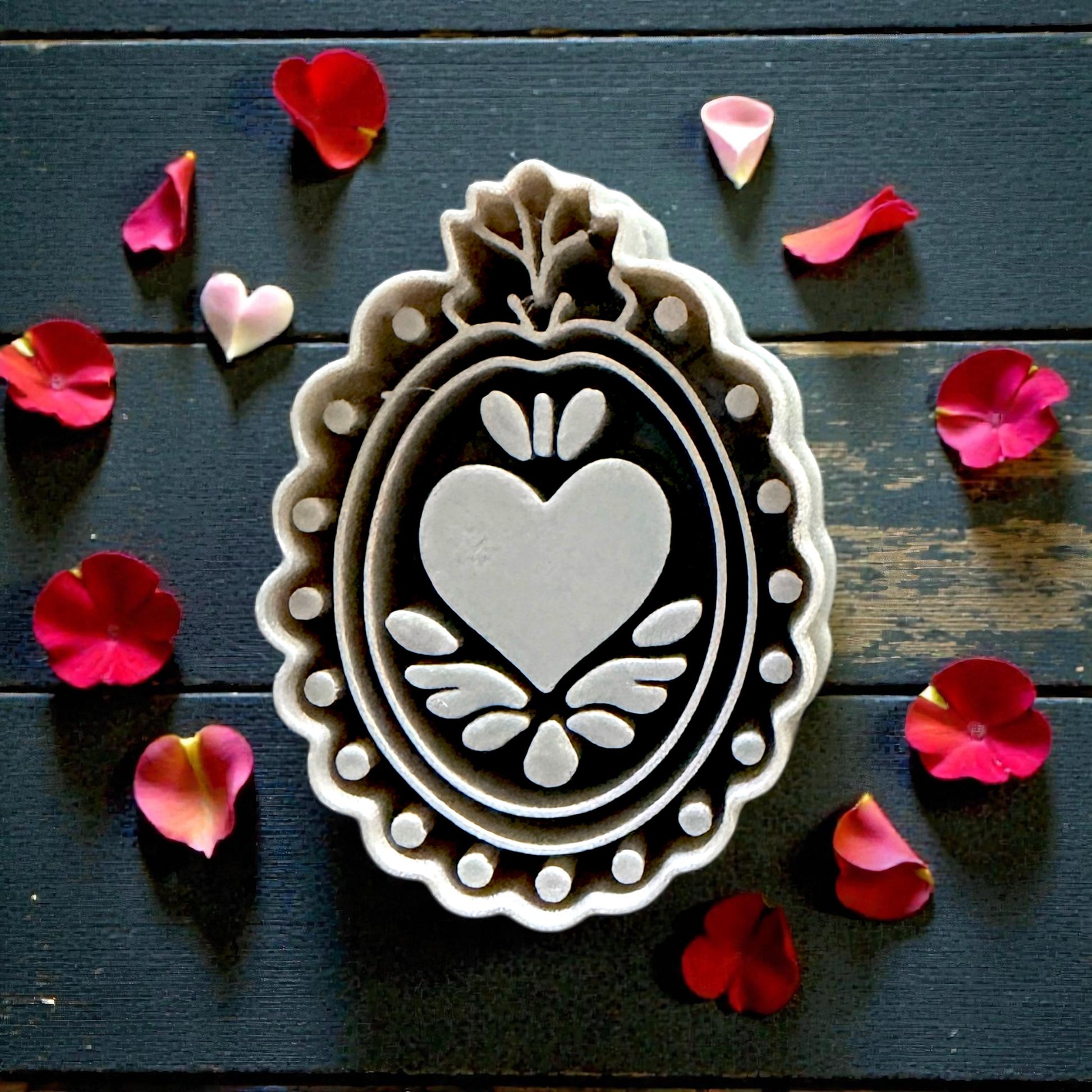 close up of grey ornate heart-frame cutter on tile