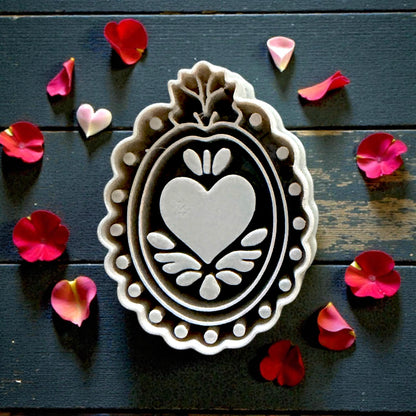 close up of grey ornate heart-frame cutter on tile