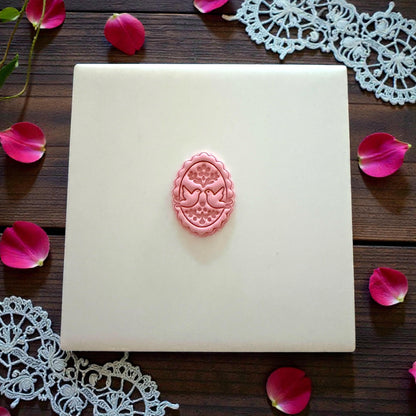 Pink lovebird oval imprint centered on white tile with lace and petals
