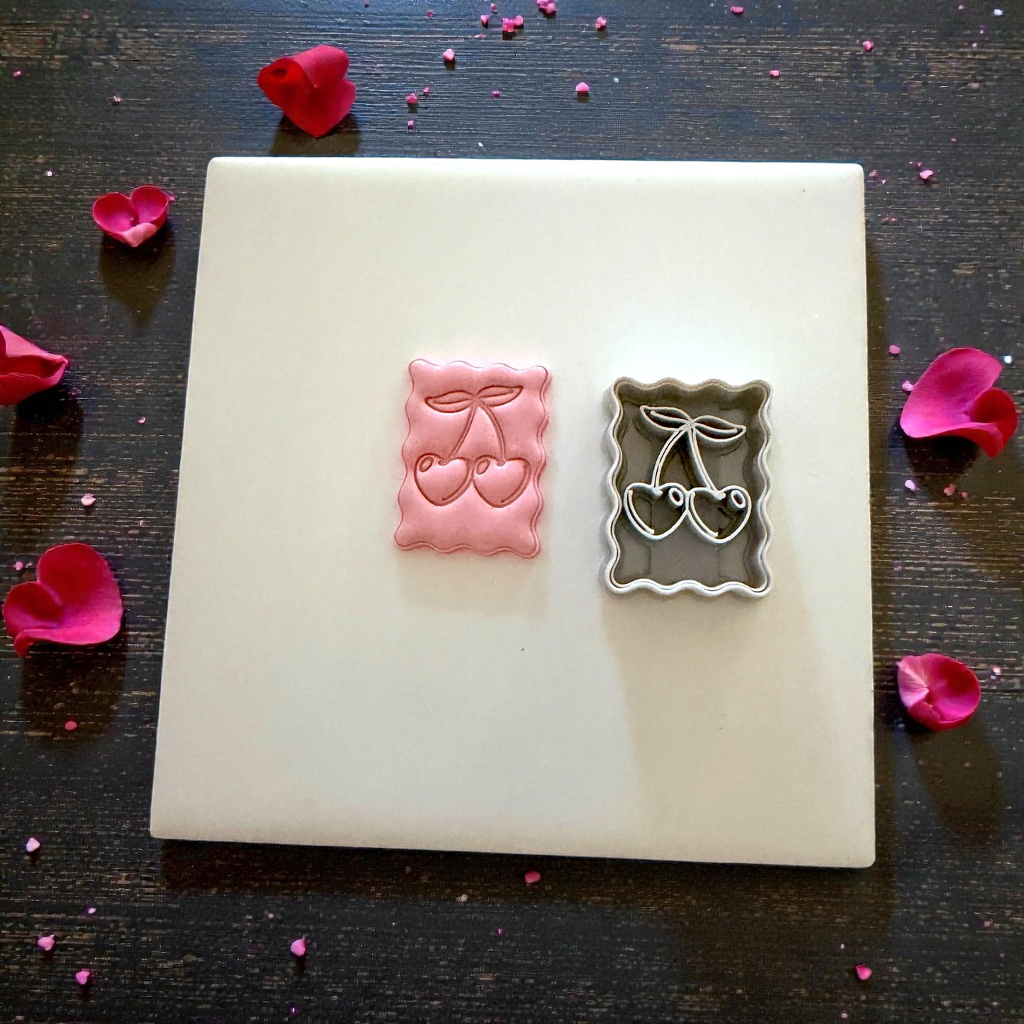 cherry clay impression and cutter flatlay with petals