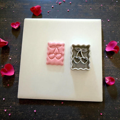 cherry clay impression and cutter flatlay with petals