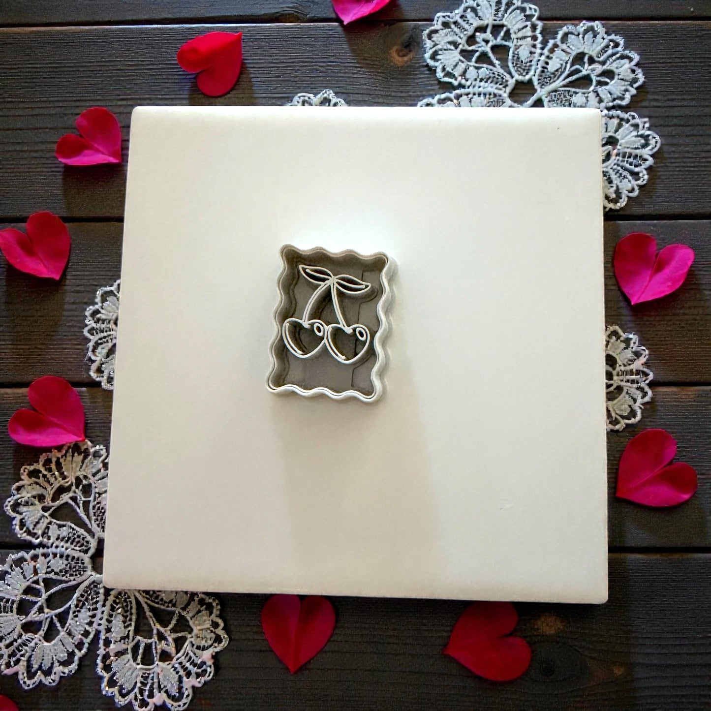 cherry cutter on tile with rose petals