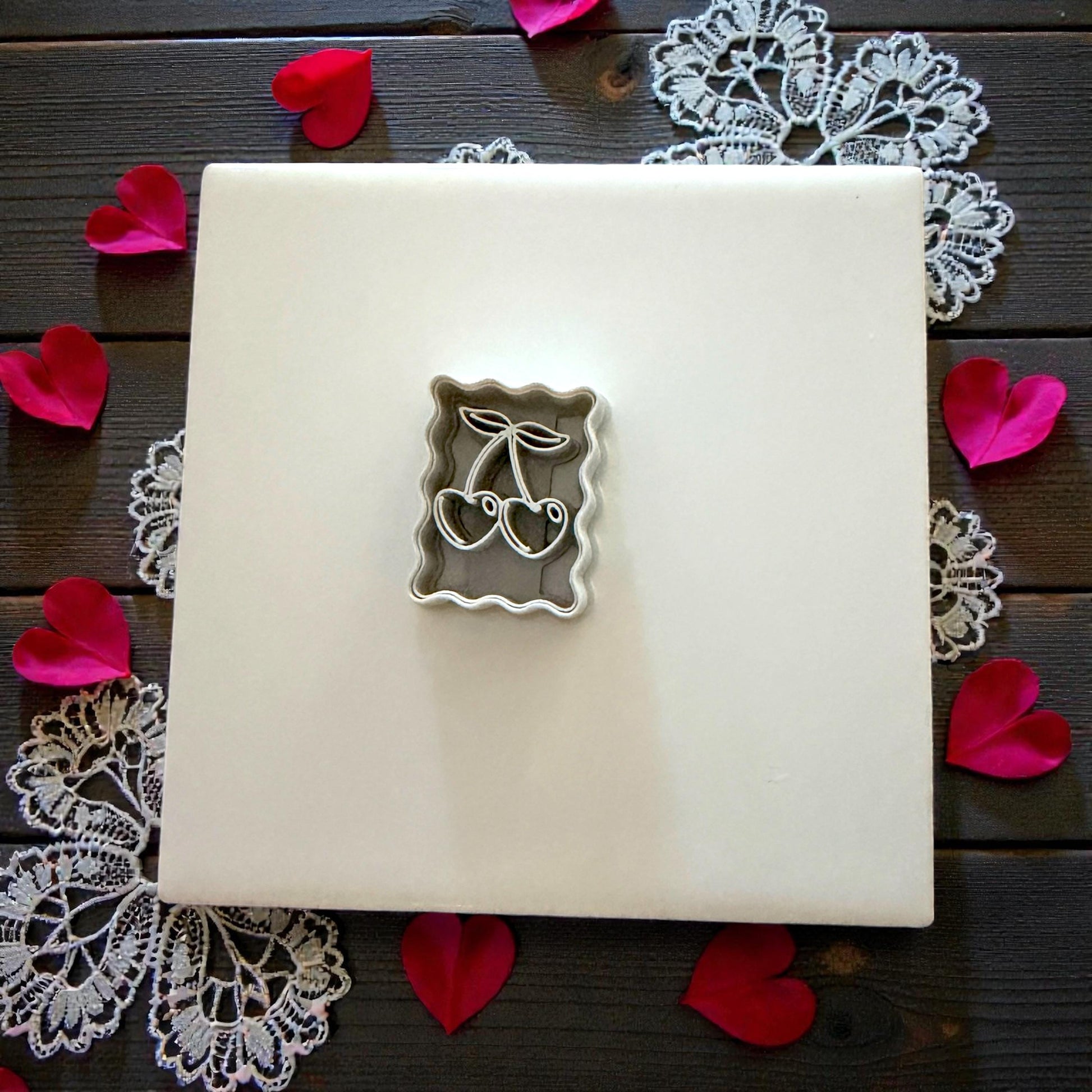 cherry cutter on tile with rose petals