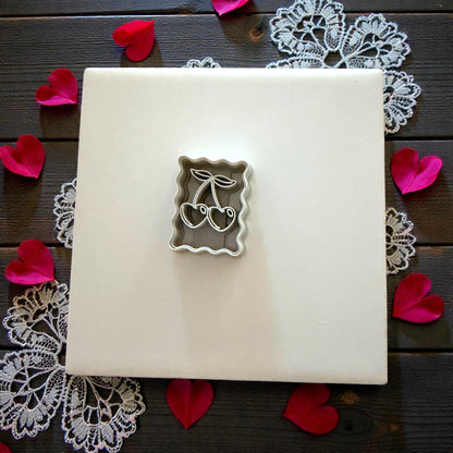 cherry cutter on tile with rose petals